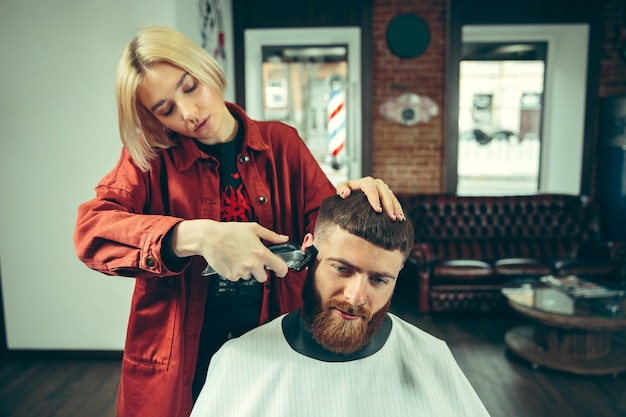 Client during beard shaving in barbershop