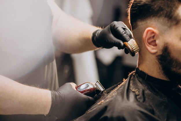 Client doing hair cut at a barber shop salon