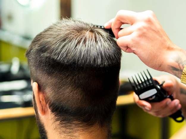 Client getting a new haircut from behind