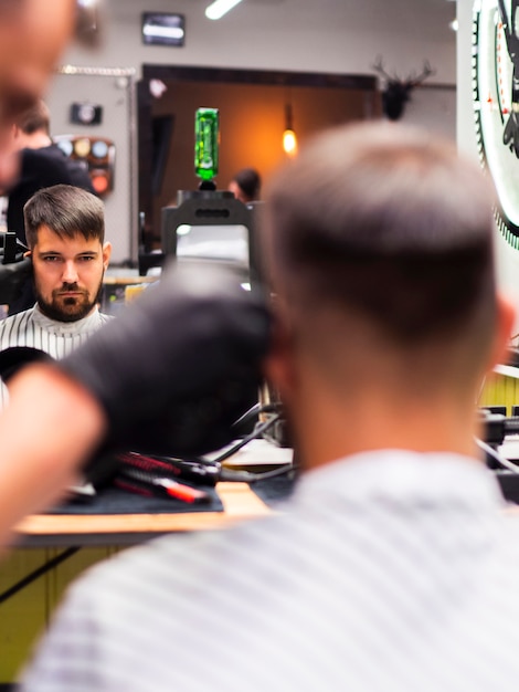 Client getting a new haircut from behind