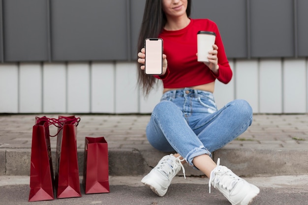 Free Photo client in red shirt sitting and holding cup of coffee