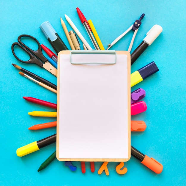 Free photo clipboard lying on stationery