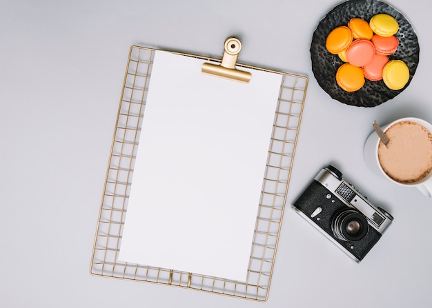 Clipboard with camera, cookies and coffee