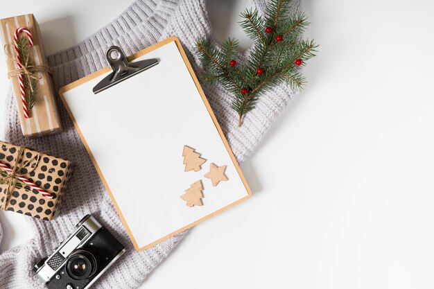 Clipboard with gift boxes and fir tree branches