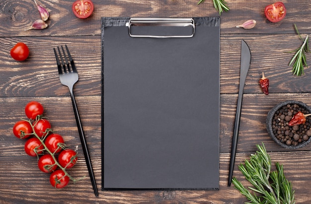 Clipboard with tomatoes and cutlery