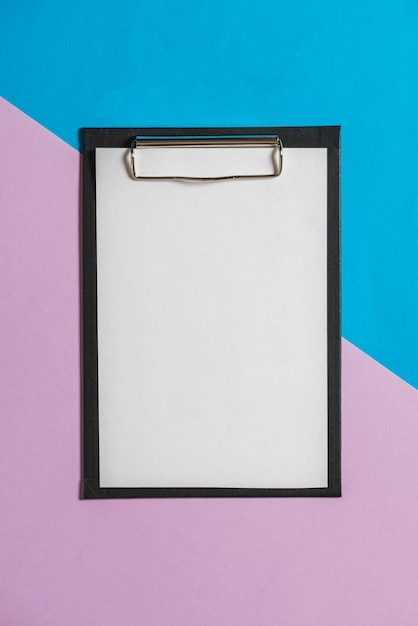 Free photo clipboard with white sheet over color papers