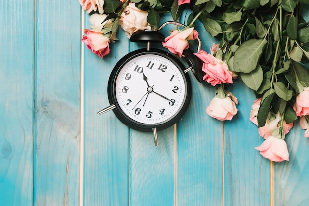 Clock and pink roses