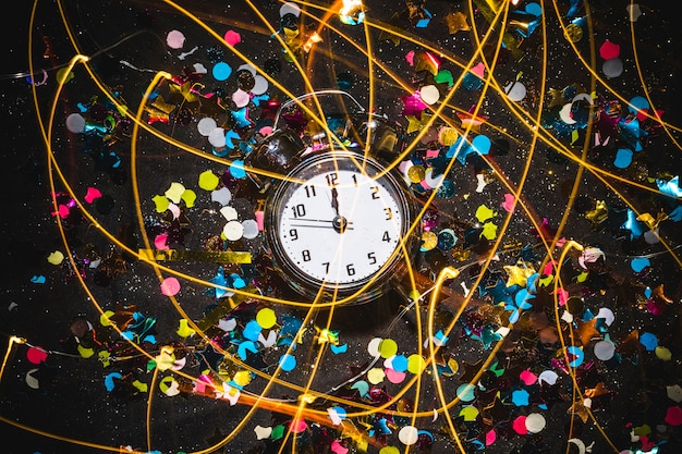 Free photo clock with spangles on black table