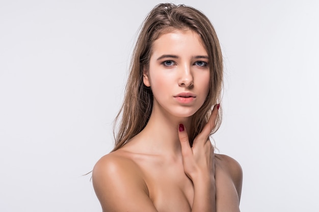 Close portrait of tiny brunette model girl without clothes with fashion hairdo isolated on white background