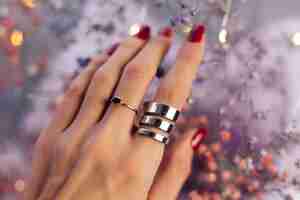 Free photo close shot of  woman hand fingers wearing two rings