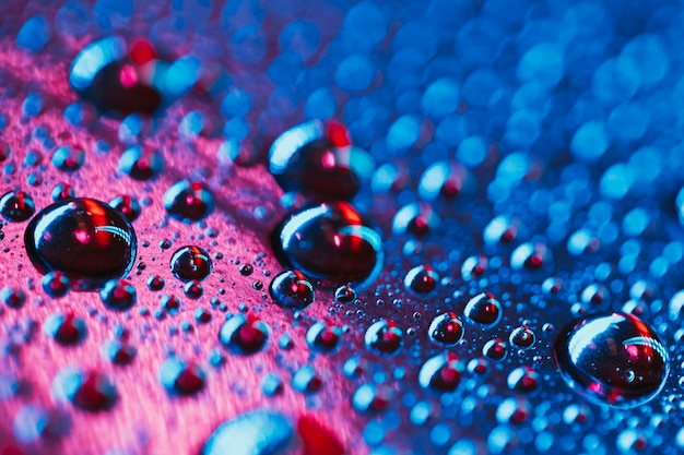 Free photo close-up of abstract water bubbles with pink and blue background