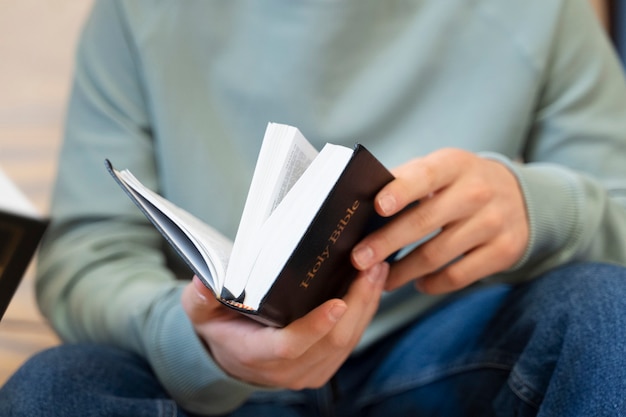 Close up on adult praying an reading