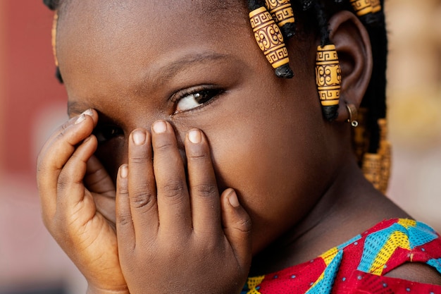 Close-up african girl covering her face