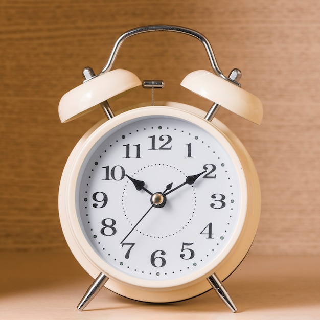 Close-up of an alarm clock on wooden background