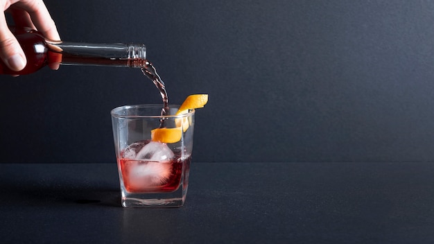 Close-up alcohol pouring into glass