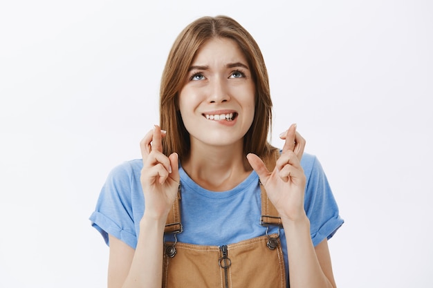 Free photo close-up of anxious and worried girl praying, cross fingers good luck