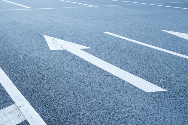 Close-up of arrow painted on the asphalt