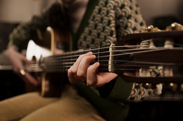 Close up artist playing the guitar