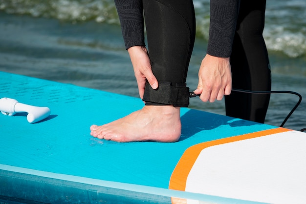 Close up athlete preparing for paddleboarding