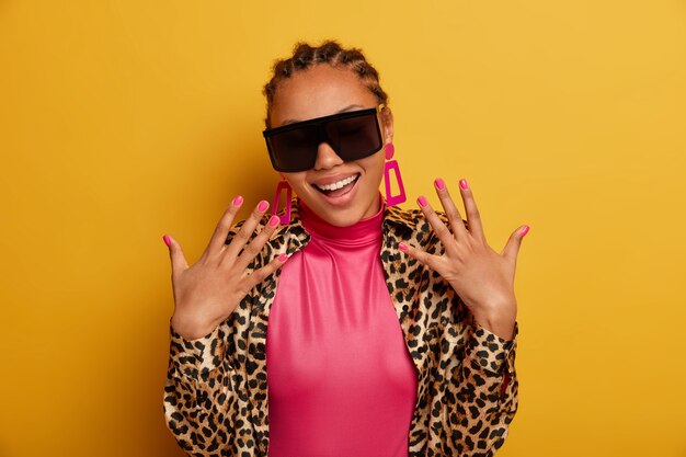 Close up on attractive carefree young woman wearing sunglasses