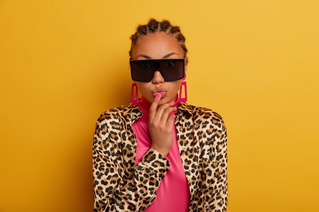 Close up on attractive carefree young woman wearing sunglasses