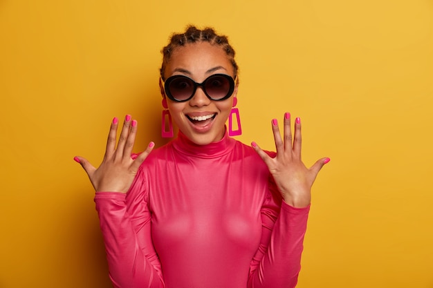 Close up on attractive carefree young woman wearing sunglasses