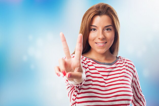 Close up of attractive woman, who showing peace sign