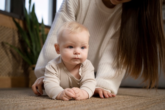 Close up on baby crawling and learning to walk