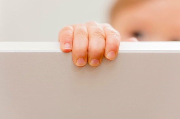 Free Photo close-up baby hand on crib