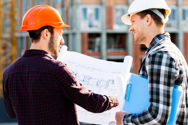 Free Photo close-up back view of engineer and architect supervising construction