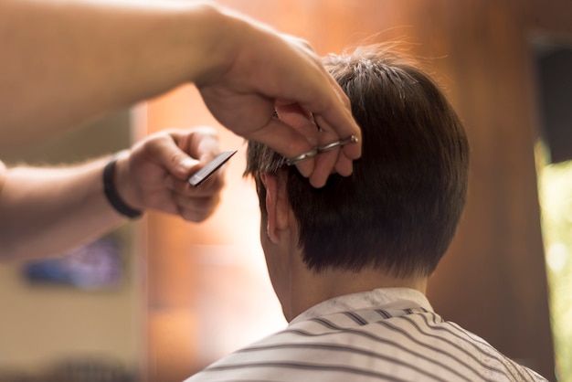 Close up back view man getting a haircut