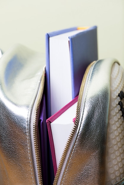 Close-up of backpack with several books