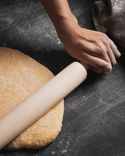 Close-up baker hand rolling composition 