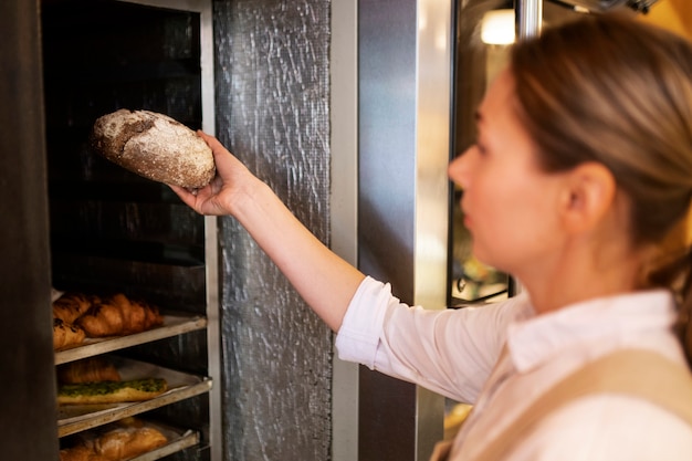 Close up baker holding bread