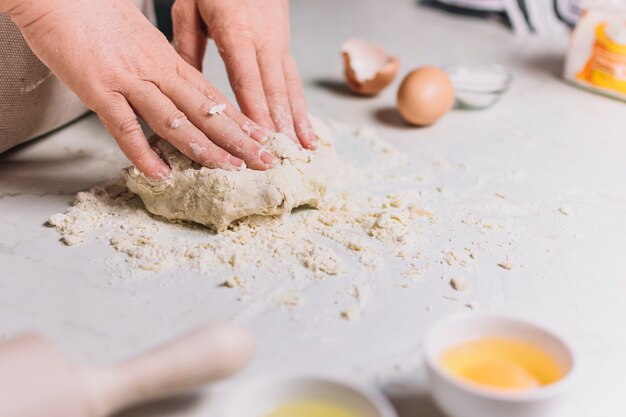 Free photo close-up of a baker's hand kneading dough