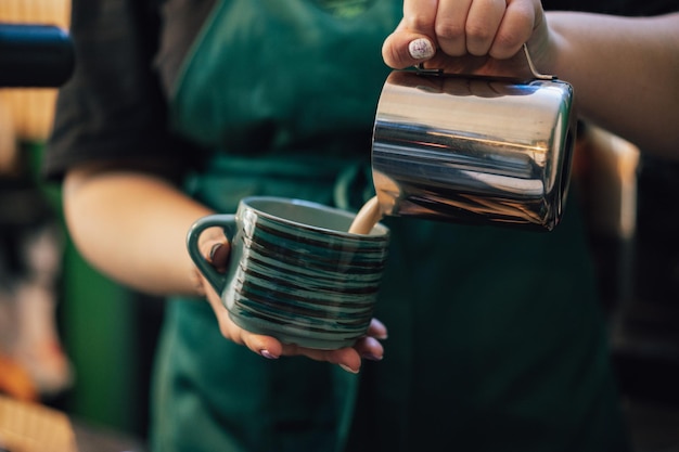 Free photo close up of barista hands preparing coffee for customer in coffee shop