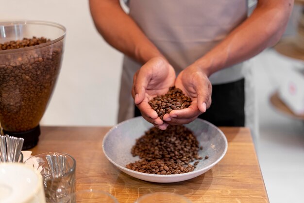 Close up barista holding coffee beans