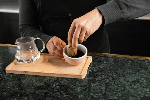 Close-up barista preparing coffee