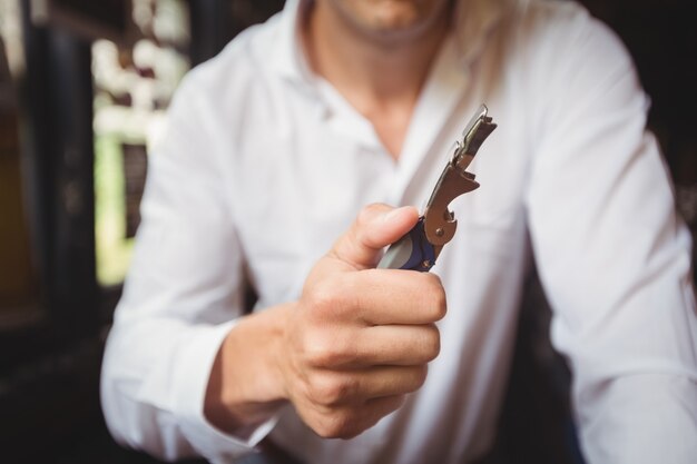 Close-up of bartender a bottle opener