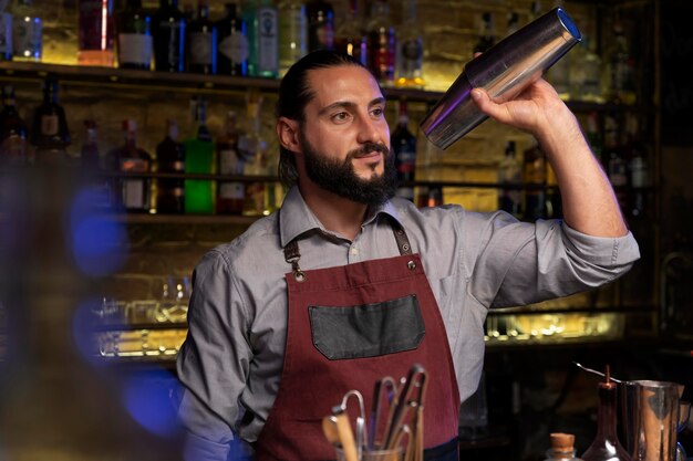 Close up on bartender and cocktail shaker