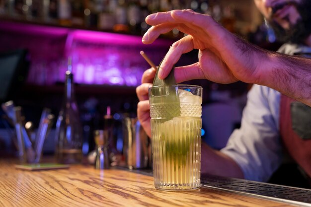 Close up on bartender and cocktail shaker