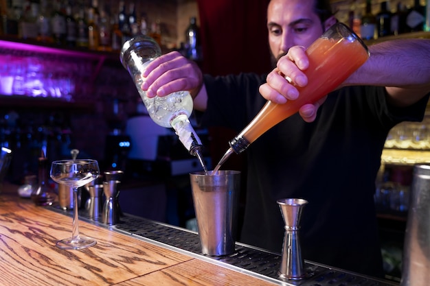 Close up on bartender and cocktail shaker