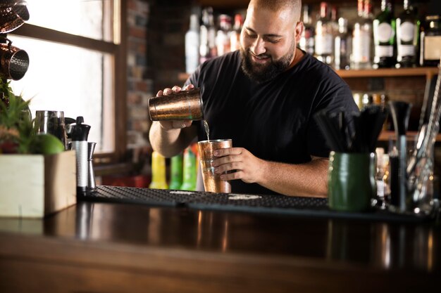 Close up on bartender creating delicious drink