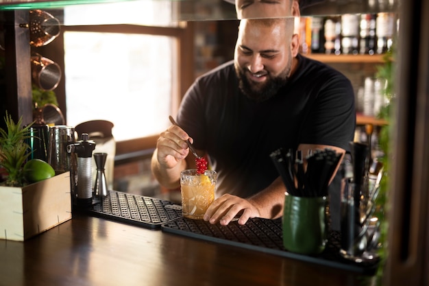 Close up on bartender creating delicious drink