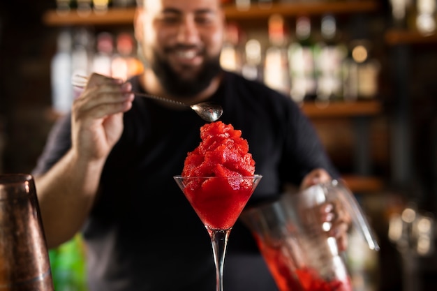 Close up on bartender creating delicious drink