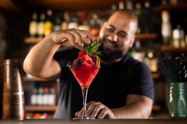 Close up on bartender creating delicious drink