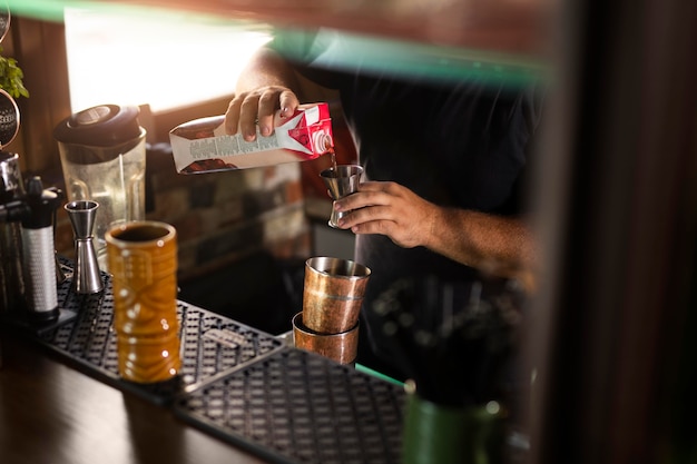 Free photo close up on bartender creating delicious drink