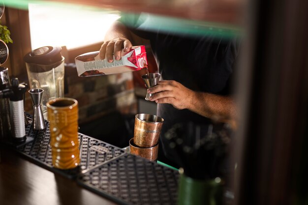 Close up on bartender creating delicious drink