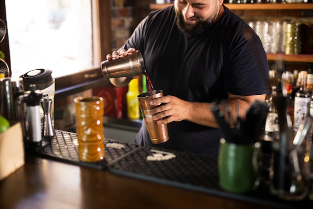 Close up on bartender creating delicious drink