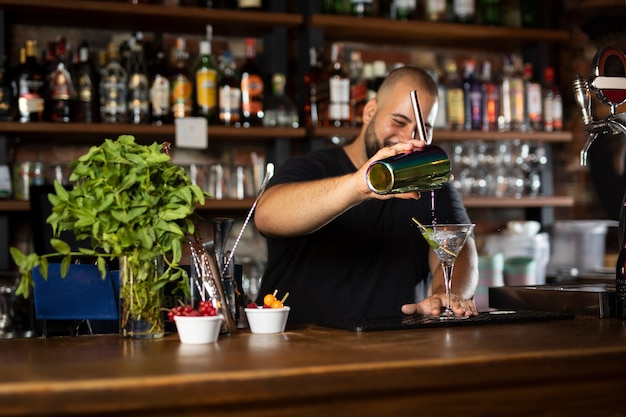 Close up on bartender creating delicious drink